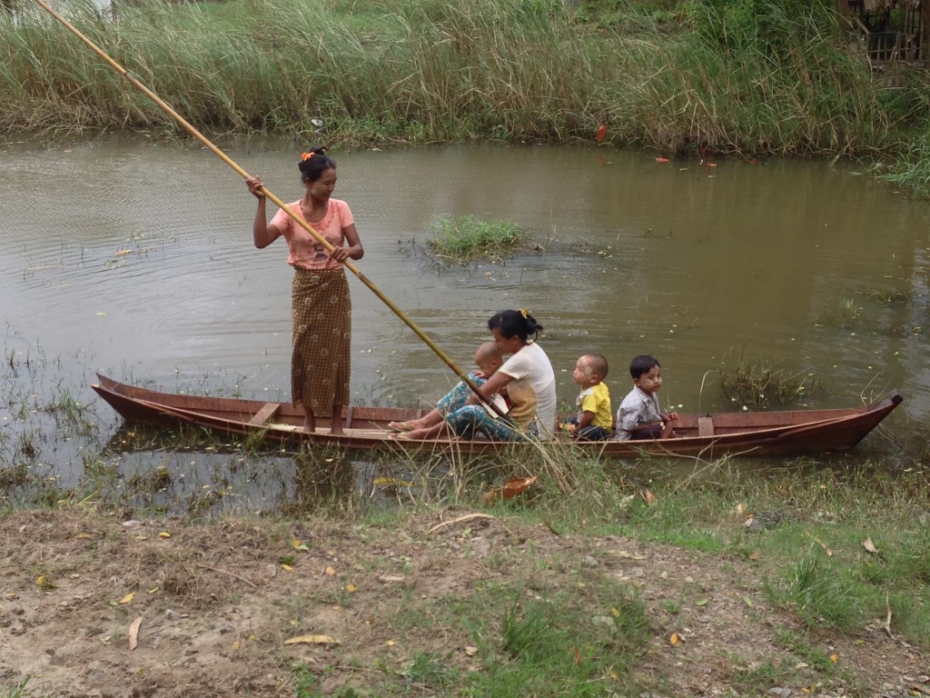BRAC Village Organization members come to a meeting by boat through the floodwaters brought on by the monsoon season.
